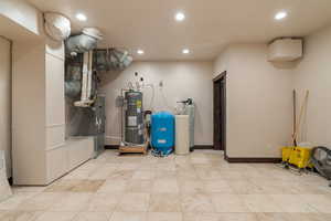 Utility room with strapped water heater and heating unit