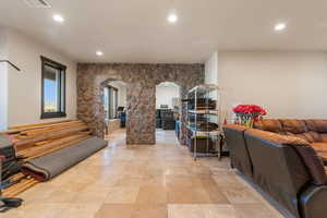 Hallway with arched walkways and recessed lighting