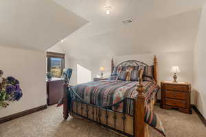 Bedroom featuring baseboards and light colored carpet