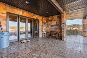 View of patio / terrace featuring a mountain view and french doors