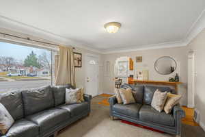 Living room with arched walkways and wood finished floors