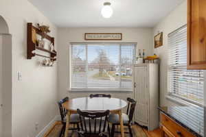 Dining area with baseboards and wood finished floors