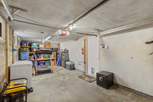 Basement featuring a garage and white refrigerator
