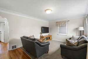 Living area featuring baseboards and wood-type flooring