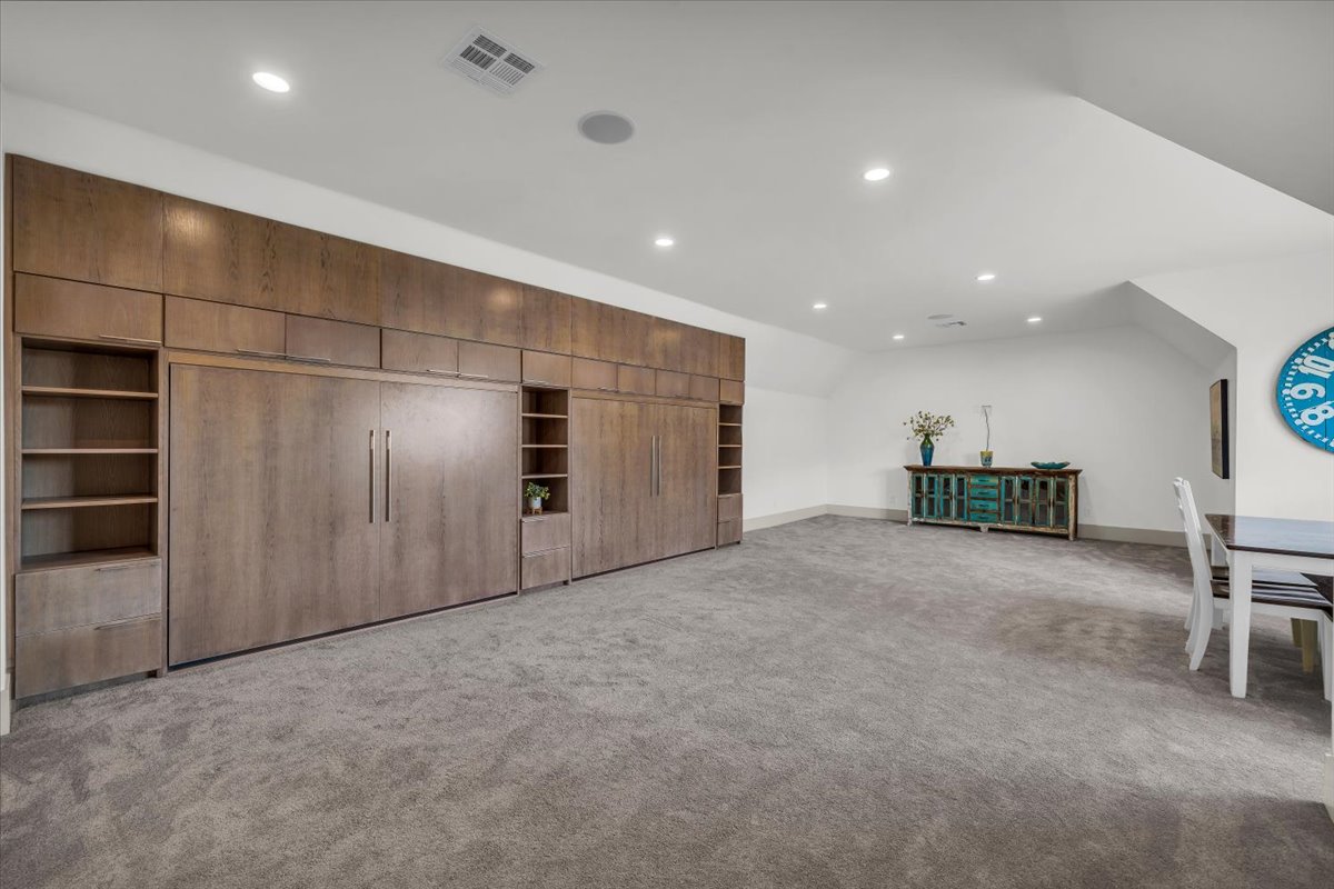 Bonus room with recessed lighting, light colored carpet, and vaulted ceiling