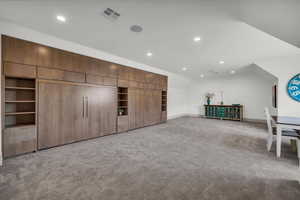 Bonus room with recessed lighting, light colored carpet, and vaulted ceiling