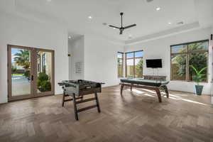 Playroom featuring french doors, pool table, ceiling fan, a raised ceiling, and recessed lighting