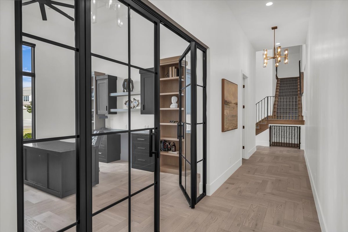 Hall featuring parquet flooring and suspended lighting