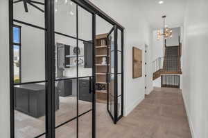 Hall featuring parquet flooring and suspended lighting