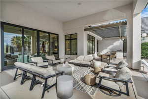 View of patio with an outdoor living / dining area and a pergola