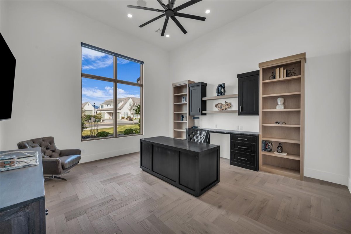 Office space featuring parquet flooring and recessed lighting