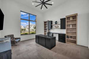 Office space featuring parquet flooring and recessed lighting