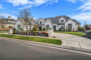 View of front of house featuring curved driveway
