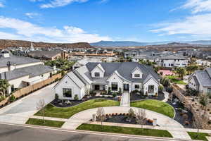 View of front of property with a residential view, concrete driveway, and a mountain view