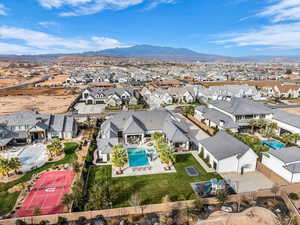 Aerial view of residential area with a pool and a mountain backdrop