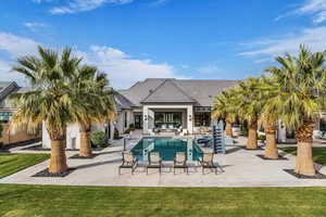 Swimming pool with a patio and a lawn