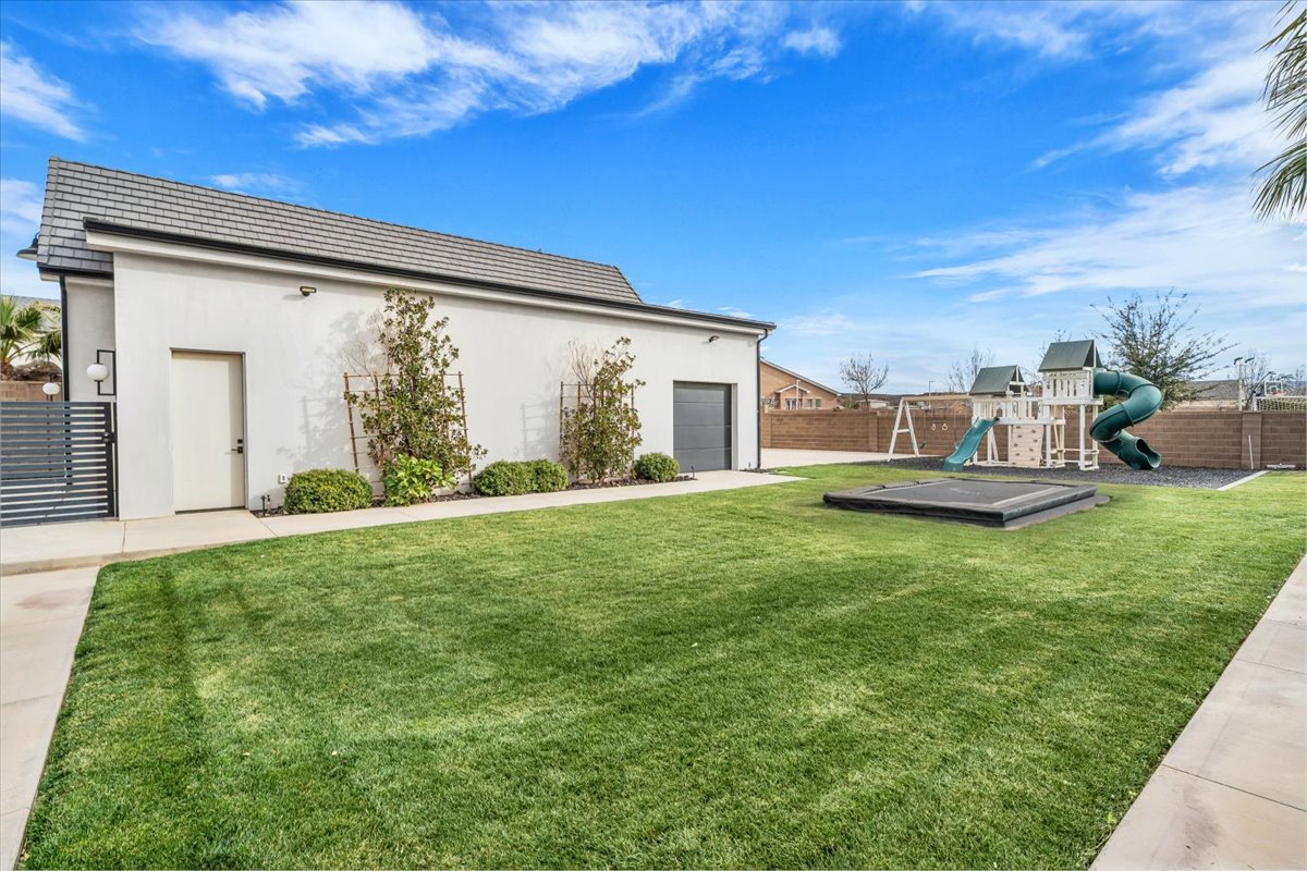 Fenced backyard with an attached garage