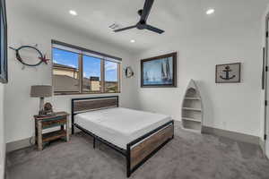 Carpeted bedroom featuring a ceiling fan and recessed lighting