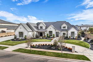 View of front of home featuring curved driveway, a porch, and stucco siding
