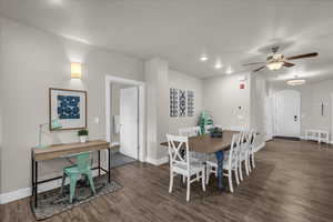 Dining area with dark wood-style floors, a ceiling fan, and recessed lighting
