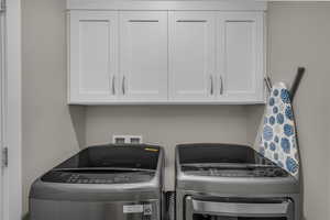 Laundry room with cabinet space and separate washer and dryer