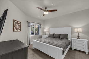 Bedroom featuring carpet and ceiling fan