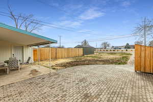 Fenced backyard with a patio area