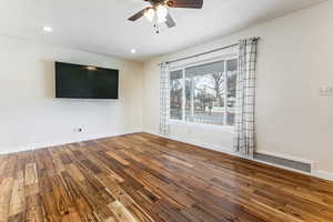 Spare room with dark wood-type flooring, a ceiling fan, a textured ceiling, and recessed lighting