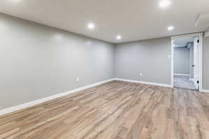 Finished basement with recessed lighting and light wood finished floors