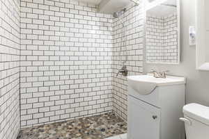 Full bathroom with vanity and a stall shower