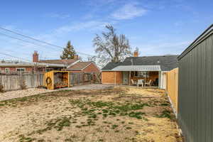 Fenced backyard with a patio area and a gate