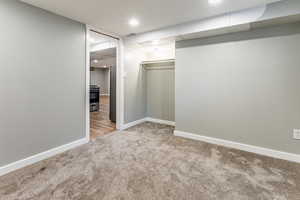 Walk in closet with light carpet
