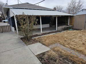 View of property exterior featuring a chimney and roof with shingles