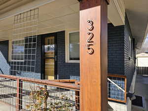 Entrance to property with brick siding