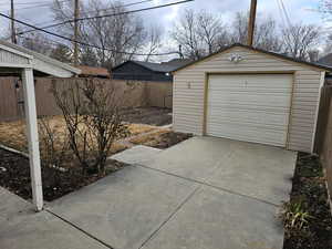 Detached garage featuring concrete driveway