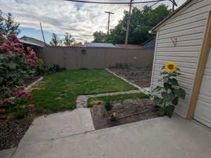 Fenced backyard featuring a gate and a patio