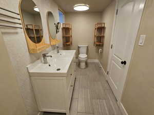 Full bathroom featuring double vanity and light wood finished floors