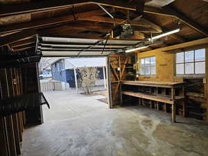 Garage featuring a workshop area and a garage door opener