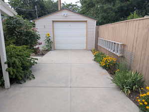 Detached garage with concrete driveway