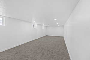 Basement with carpet floors and recessed lighting