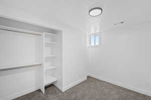 Below grade area featuring dark carpet and a textured ceiling