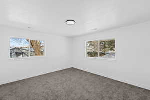 Carpeted empty room with healthy amount of natural light