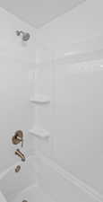 Full bath featuring shower / washtub combination