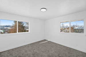 Spare room with carpet floors and a mountain view