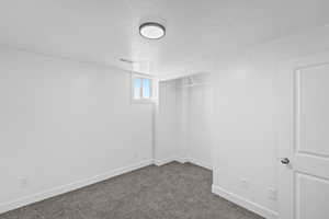 Below grade area with a textured ceiling and carpet