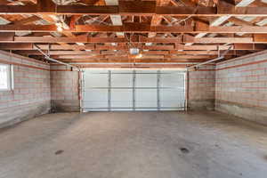 Garage with concrete block wall and a garage door opener