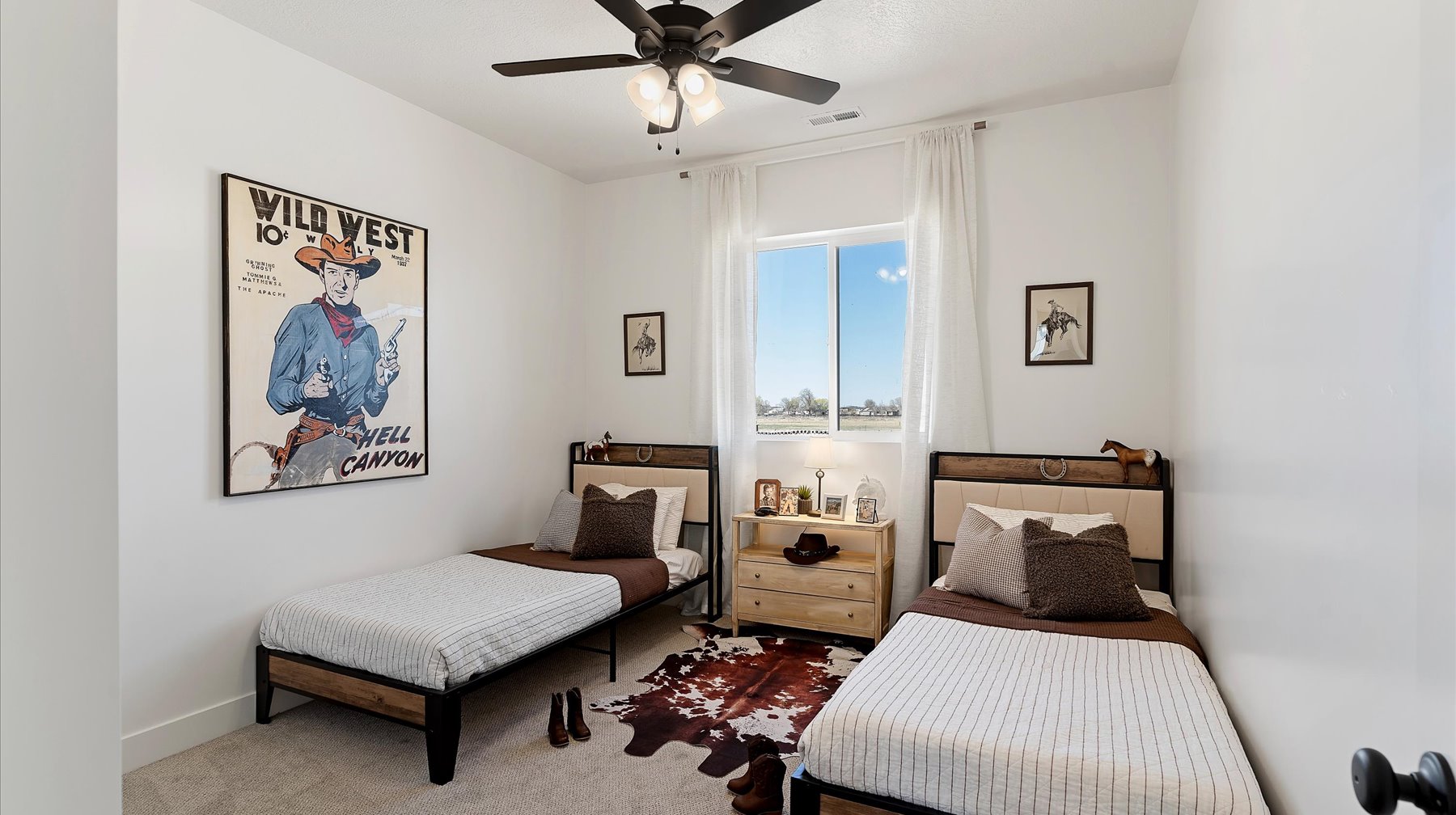 Carpeted bedroom with ceiling fan and baseboards