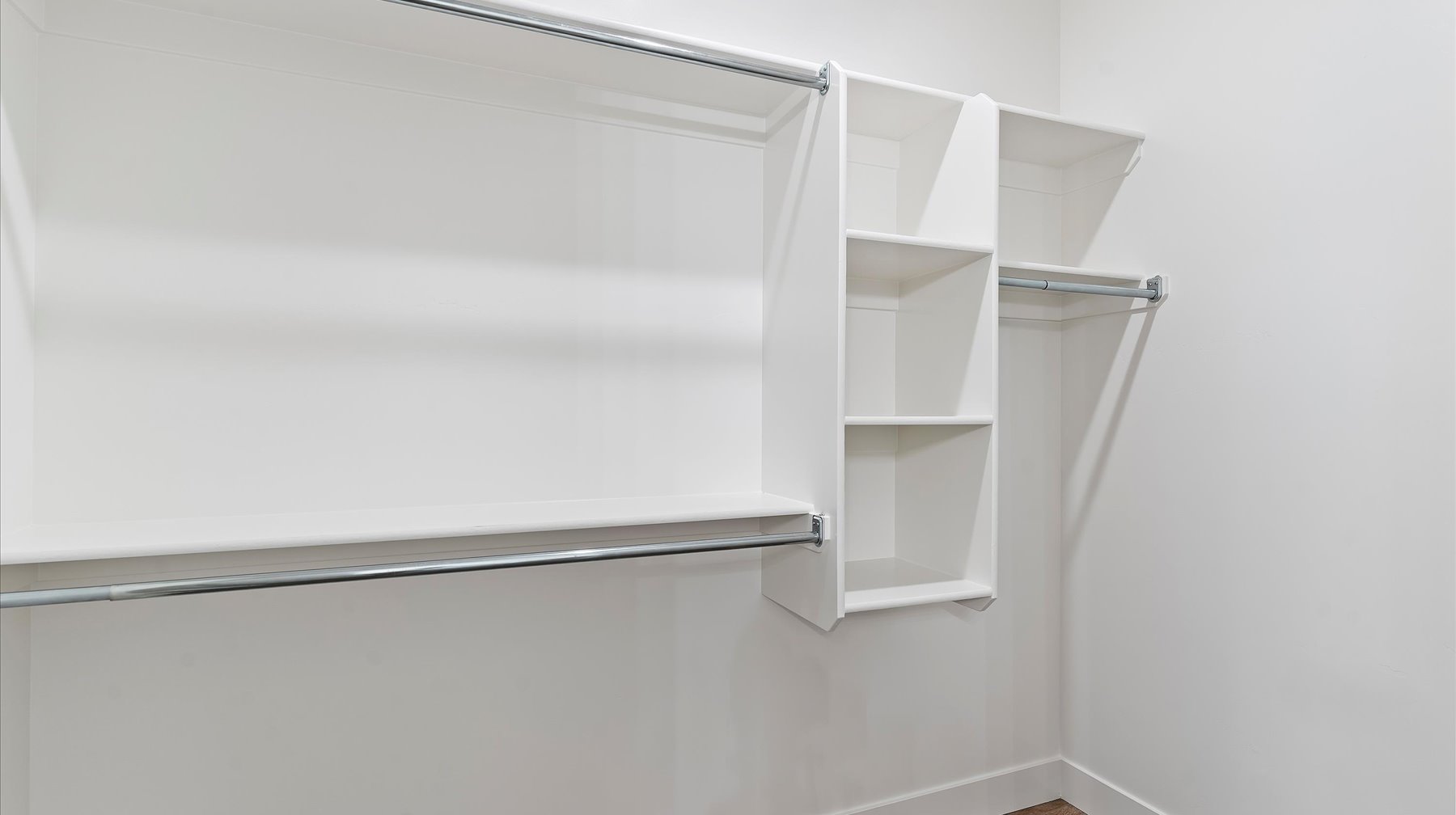 Walk in closet with wood finished floors