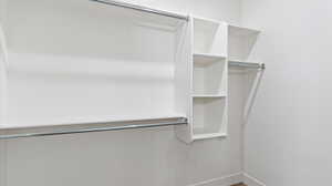 Walk in closet with wood finished floors