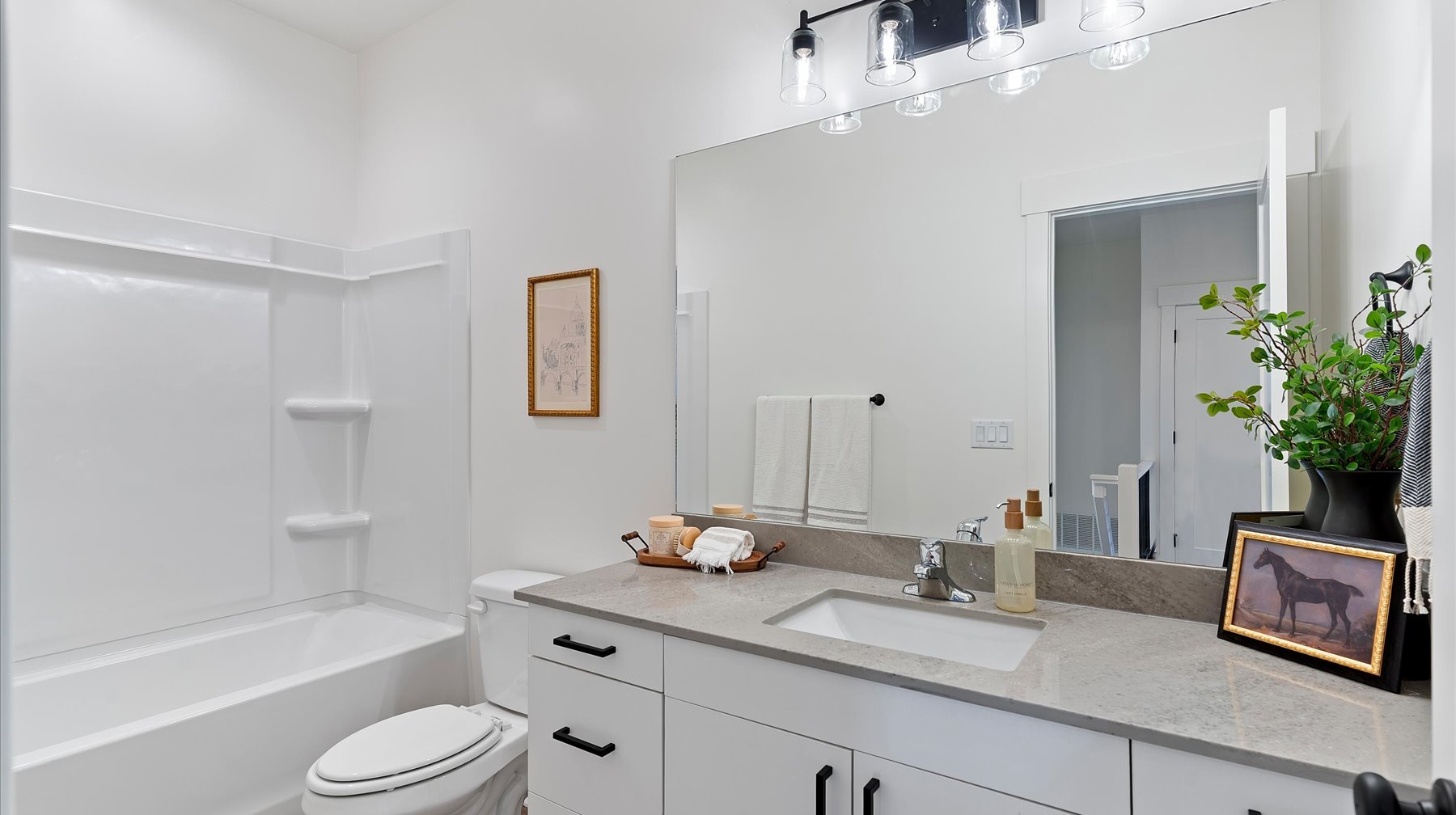 Bathroom featuring vanity and washtub / shower combination